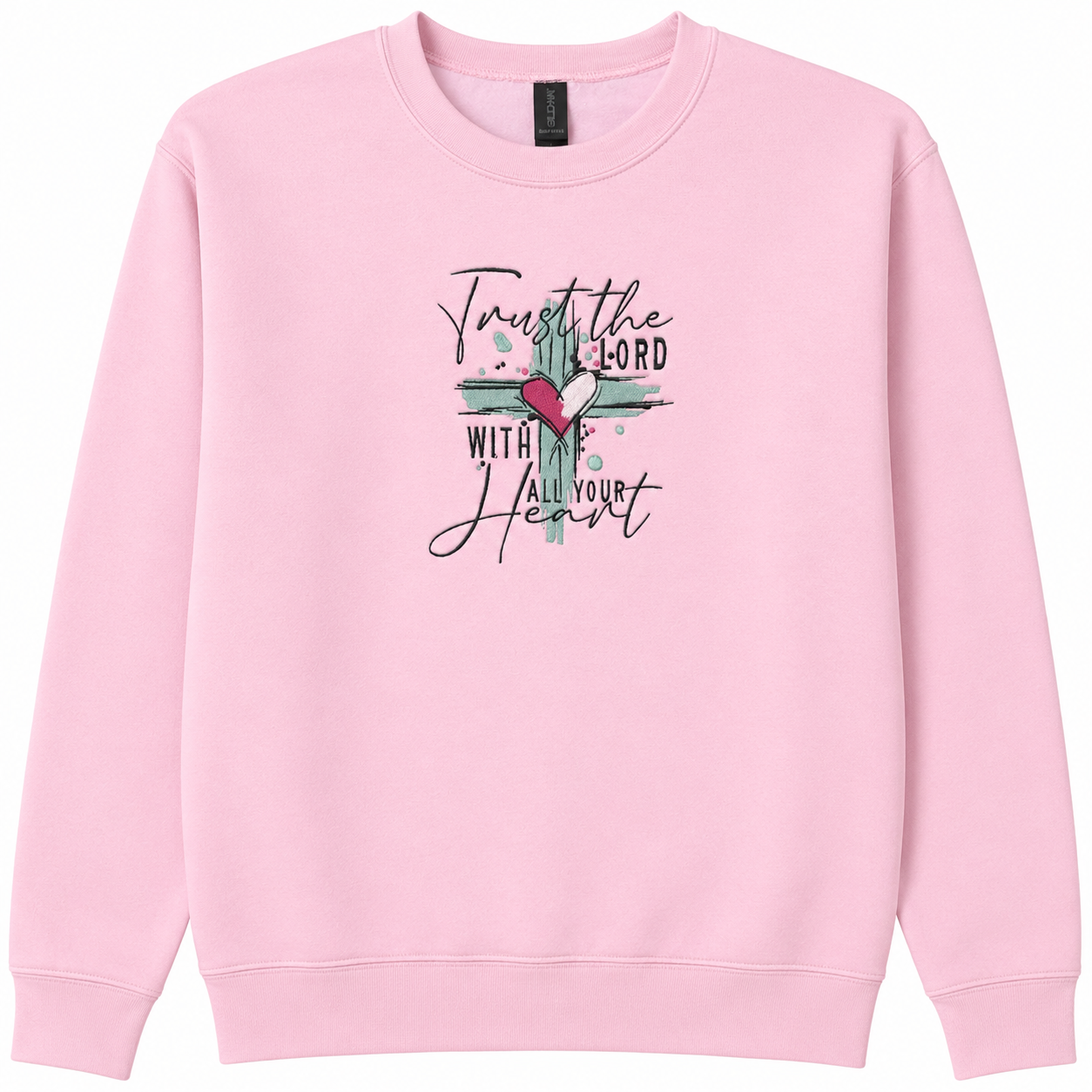 A light pink crewneck sweatshirt featuring a embroidered design  the chest with a teal cross, a red heart, and the text 'Trust the LORD with all your heart' in black script and block lettering.
