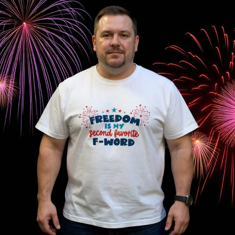 Man wearing a white t-shirt with a patriotic design and fireworks in the background