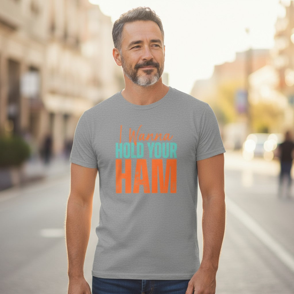 Man wearing a gray t-shirt with colorful text on a city street