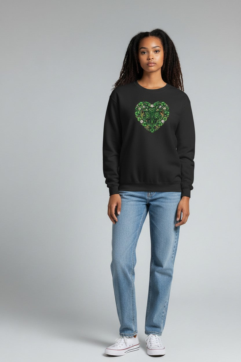 Person wearing a black sweatshirt with a green heart design and blue jeans on a gray background