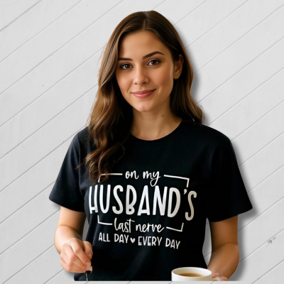 Woman wearing a black t-shirt with humorous text design, holding a knife and a cup.