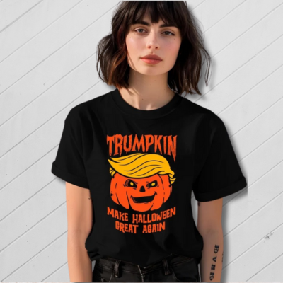 Person wearing a black t-shirt with a pumpkin and text design on a white background