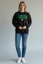 Person wearing a black sweatshirt with 'LUCKY' and a shamrock design, standing against a plain background.