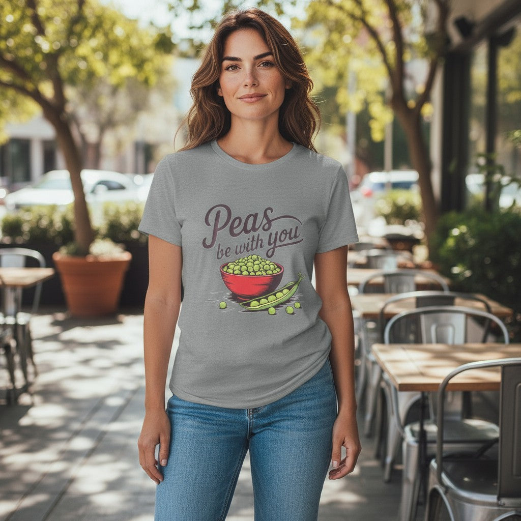 Woman wearing a t-shirt with 'Peas be with you' design in an outdoor setting.