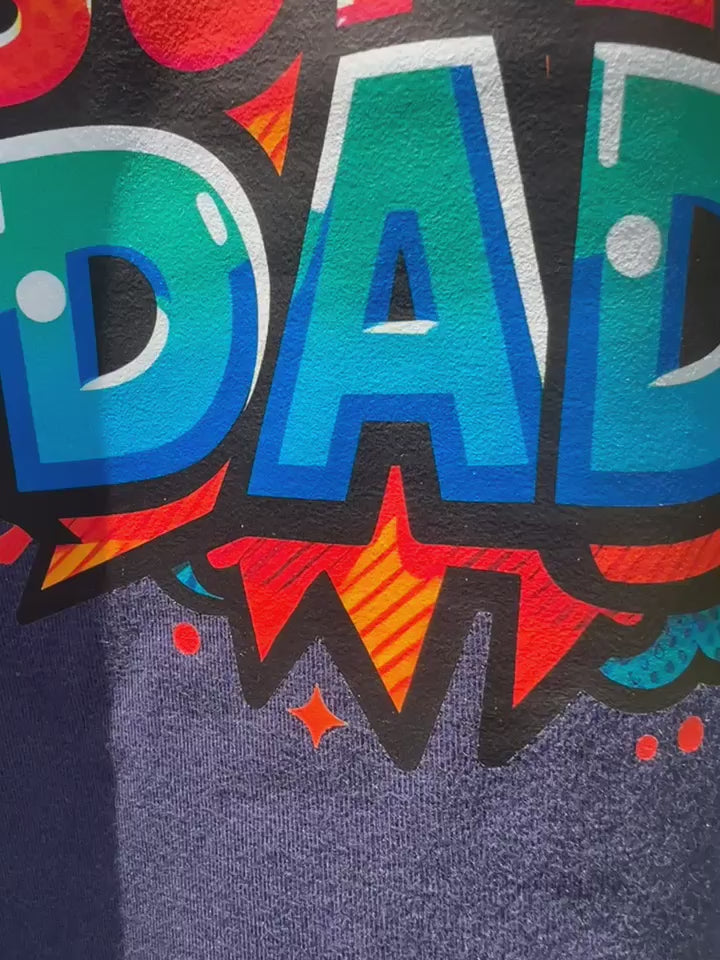 Video of Close-up of colorful Super Dad design on t-shirt.