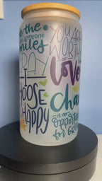 A video of  frosted glass motivational cup with colorful text