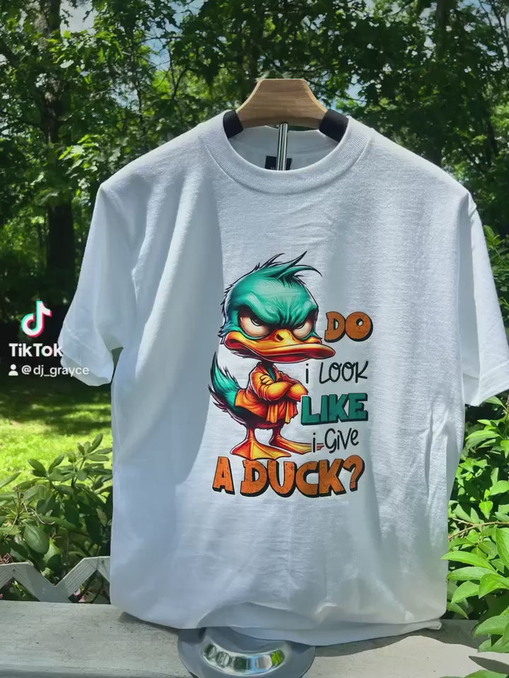 Video of cotton fabric detail of sarcastic duck graphic shirt.
