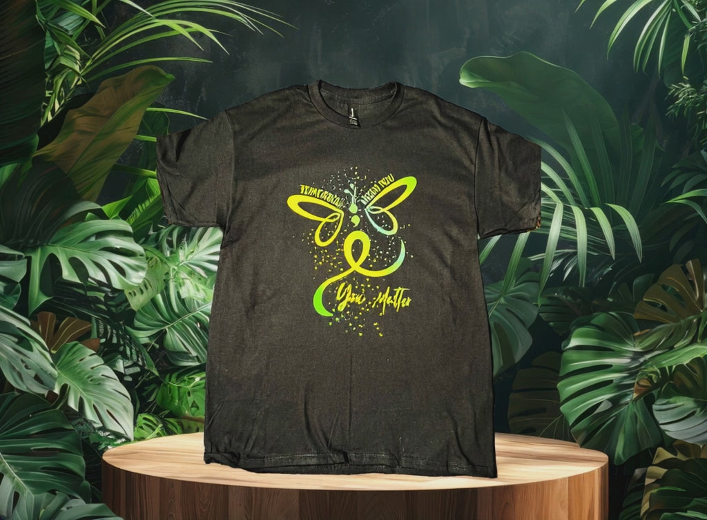 Video of Black t-shirt with a green butterfly with jungle background 