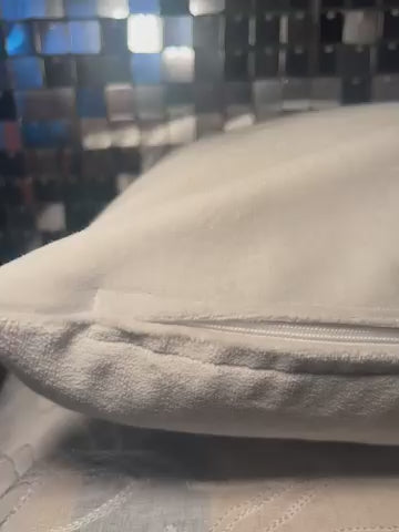 Video of handmade embroidered pillow featuring lifelike cat face with colorful flowers.