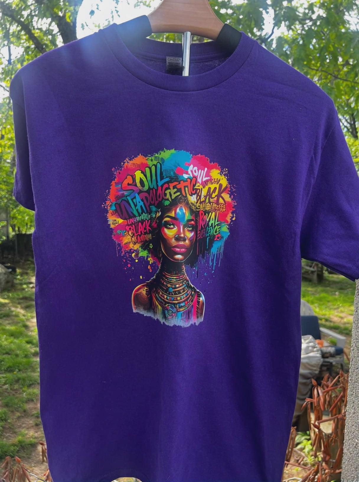 video of Purple t-shirt with colorful graphic design of a woman's face