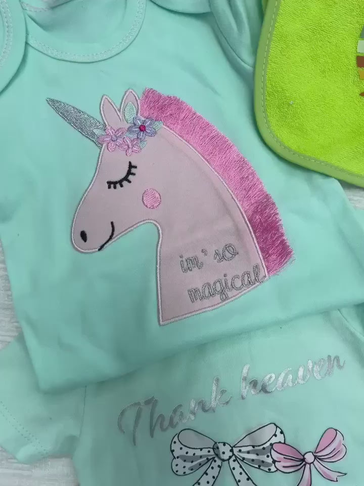 A green baby onesie with a pink unicorn with embroidery that says "I'm so Magical"