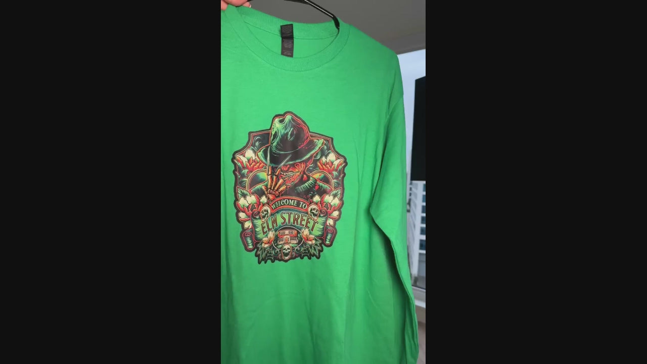Video of a green long sleeve t-shirt featuring Freddy Krueger graphic with “Welcome to Elm Street” horror design.