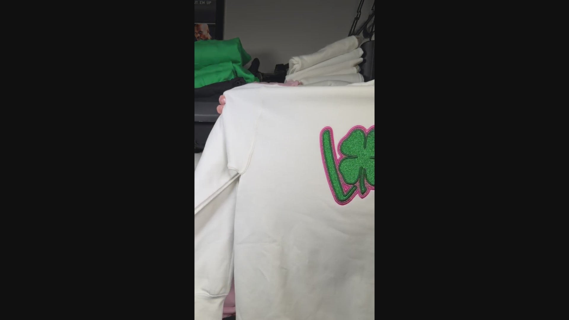 white crewneck with pink and green glitter with trending bow designs on both sides of shirt