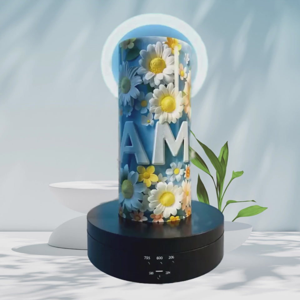 a video of a metal tumbler of a floral design and the word 'MAMA' in 3D in the clouds with a halo over it.