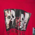 A red short-sleeved t-shirt with a graphic print featuring various horror movie characters in black masks and costumes, with the text 'Halloween Collection: The Boys of Fall'.