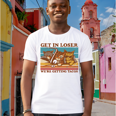Male model wearing a white Tacocat shirt on a street in mexico.