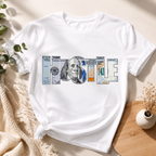A white short-sleeve T-shirt laid flat on a light beige surface, styled with a knotted hem and props including greenery, a knit blanket, and a small vase. The shirt has a large chest graphic spelling 'hustle' using Us currecy 