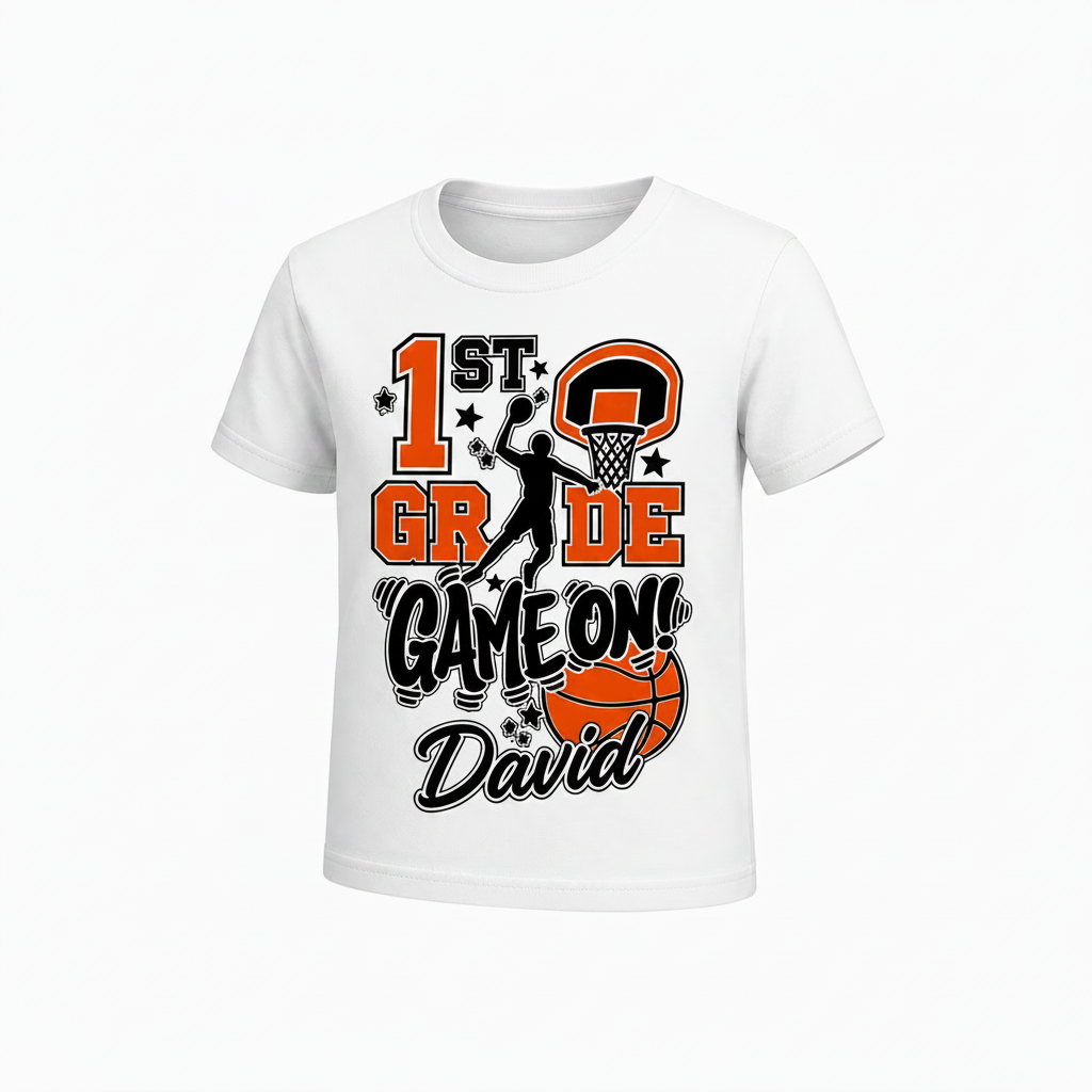 A white short-sleeve kids' t-shirt with a custom '1st Grade Game On David' basketball graphic on the front, displayed against a clean white background.