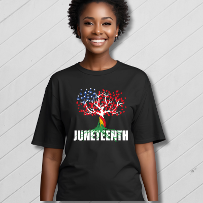 Person wearing a black t-shirt with a colorful tree design and 'JUNETEENTH' text on a gray background