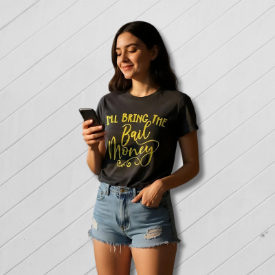 Woman wearing a black t-shirt with yellow text, standing against a light wooden panel background.