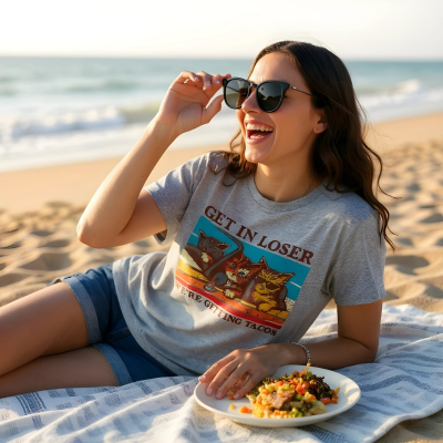 Woman model wearing Taco Cat shirt on the beach eating Mexican food.