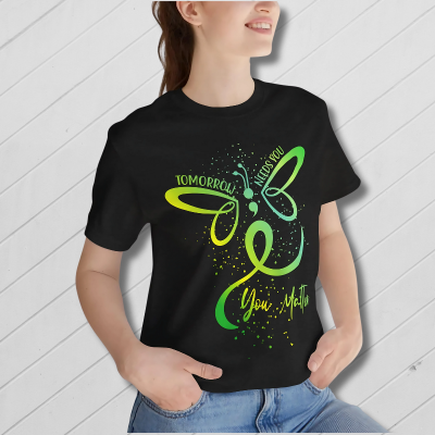 Black t-shirt with green butterfly design and text on a white background